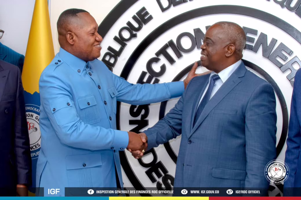Poignée de mains entre l'inspecteur général des finances sortant Jules Alingete et l'entrant Christophe Bitasimwa Bahii